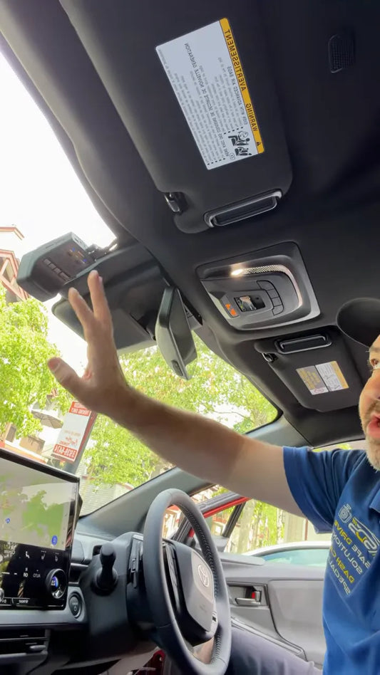 Front dash camera mounted near the top of the windshield beside the mirror