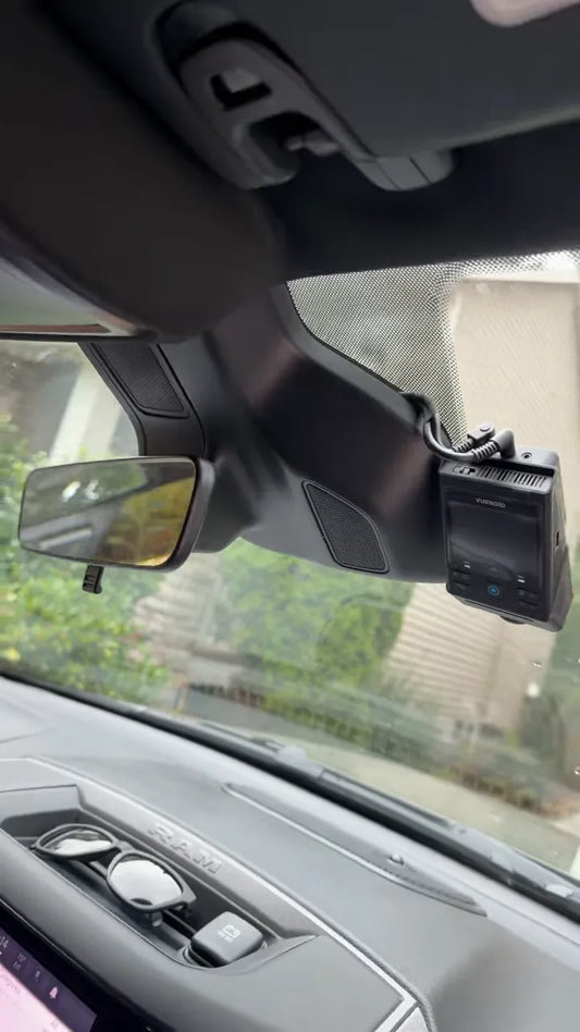 Front dash camera mounted beside the rearview mirror in a Ram 1500