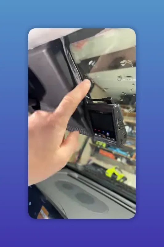 Finger pointing to VOFO A229 Pro dash camera and the cable tucked into the headliner/trim on the passenger side